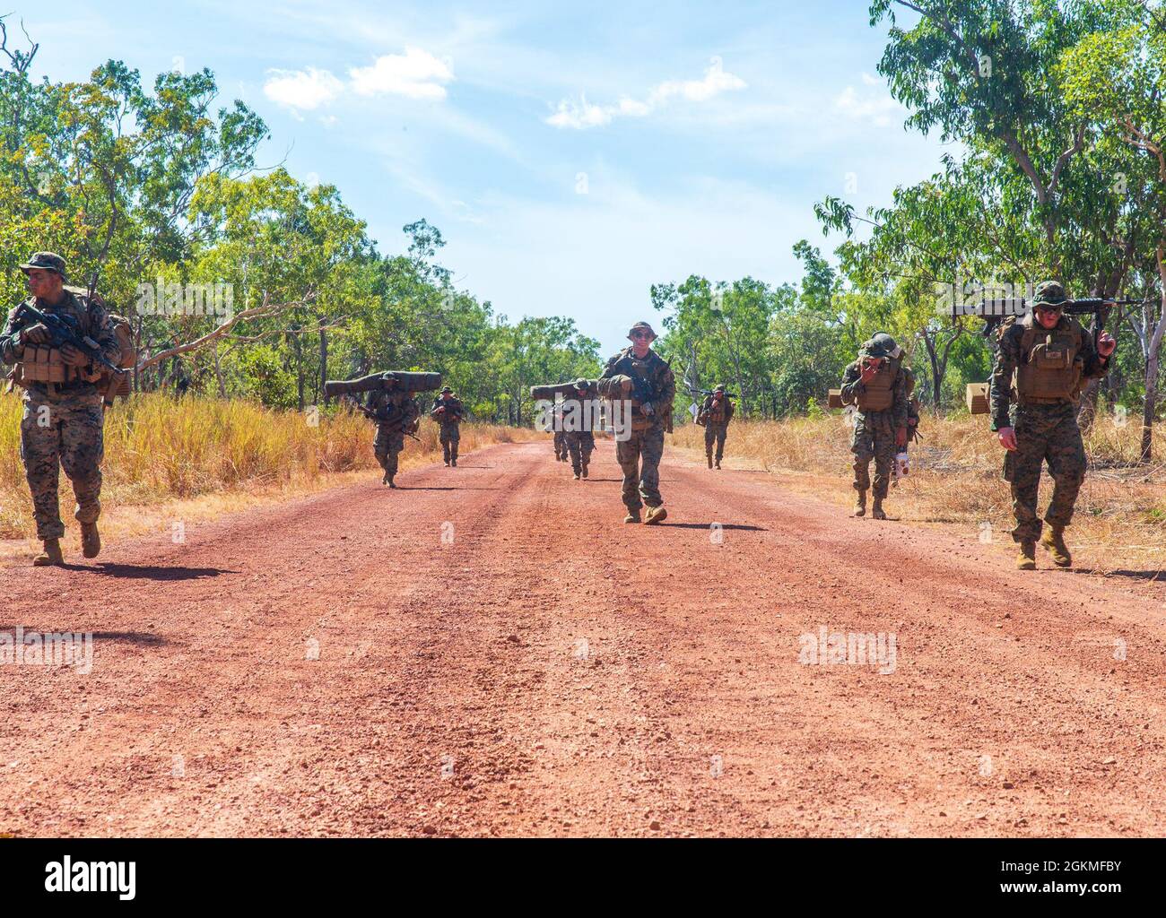 U.S. Marines with Alpha Battery, 2nd Low Altitude Air Defense Platoon, with the Aviation Combat Element, Marine Rotational Force - Darwin, walk in formation during a 6-kilometer hike at Mount Bundy Training Area, NT, Australia, May 26, 2021. Alpha Battery conducted tactical training during a three-day field evolution. 2nd LAAD is an air defense unit that is capable of providing early warning of hostile air threats to other elements of the air defense system. Stock Photo