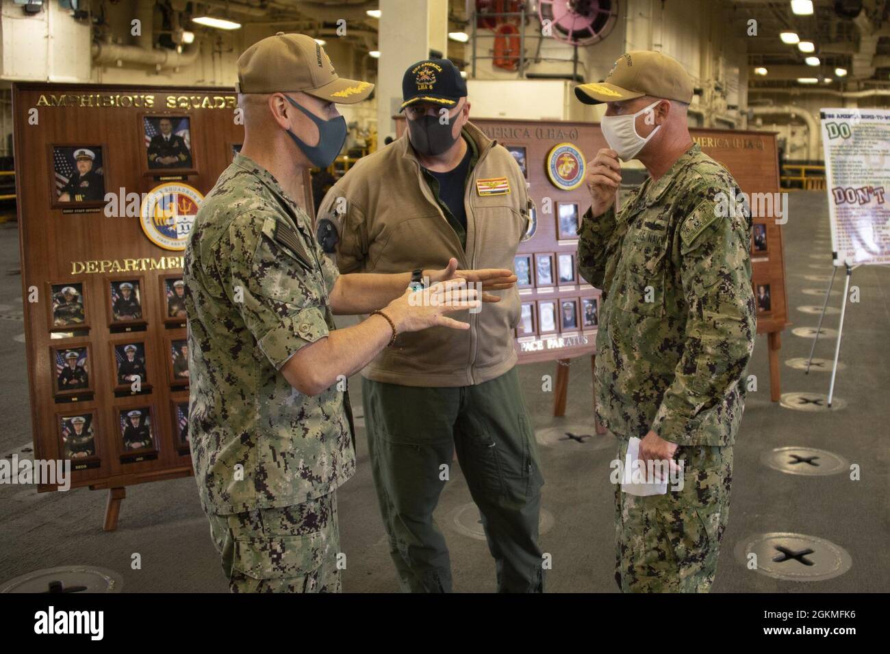 SASEBO, Japan (May 26, 2021) Rear Adm. Chris Engdahl, Commander,  Expeditionary Strike Group 7, right, meets with Amphibious Squadron 11  Commodore Capt. Greg Baker, left, and Capt. Ken Ward, commanding officer of