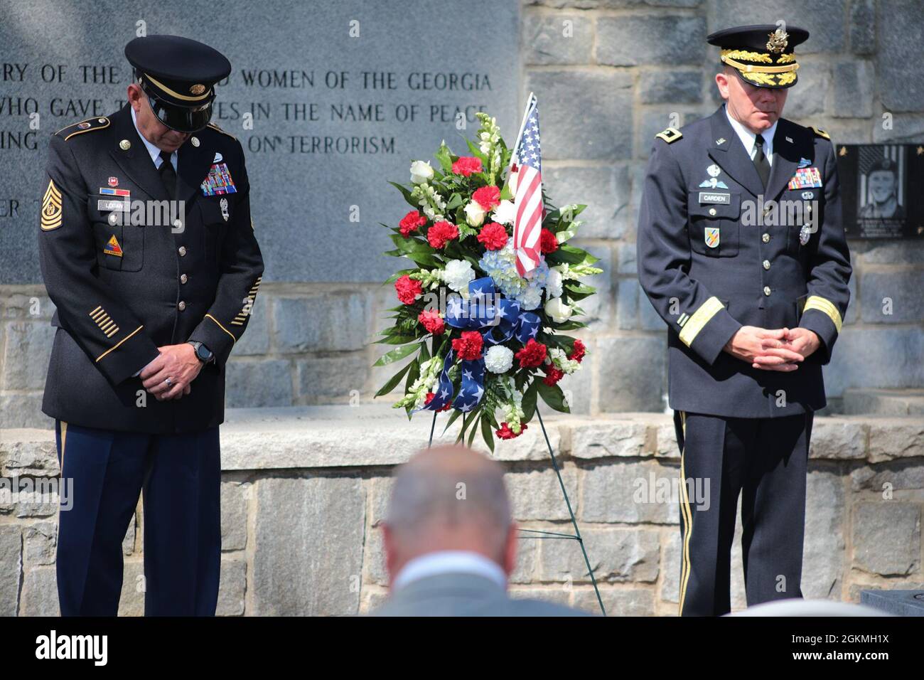 U.S. Army Maj. Gen. Thomas Carden (right), The Adjutant General of Georgia, and Command Sgt. Maj. Jeff Logan (left), the state command sergeant major of the Georgia Army National Guard, bow their heads in prayer May 27, 2021, during a Memorial Day Observation Ceremony at Clay National Guard Center in Marietta, Georgia. The Georgia National Guard memorial wall is dedicated to the memory of 43 Georgia Army National Guard Soldiers who have fallen since September 11, 2001. Stock Photo