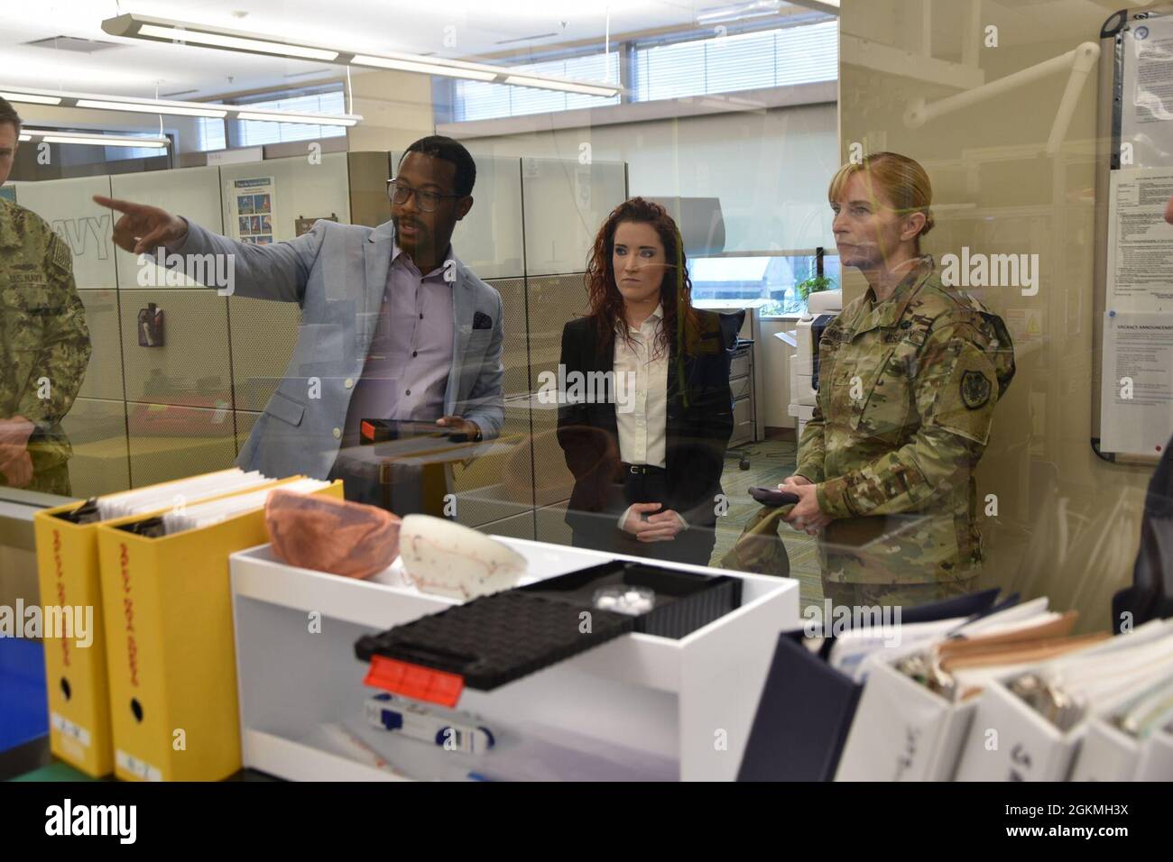 Outside a laboratory, two scientists with Naval Medical Research Unit
