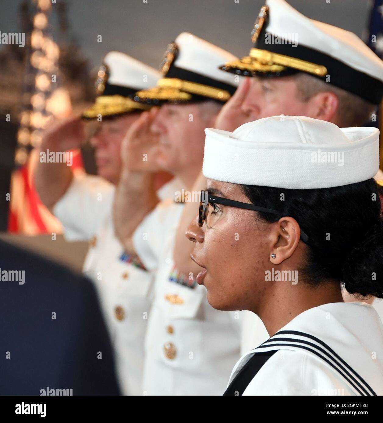 GREAT LAKES, Ill., (May 27, 2021) -- Musician 3rd Class Sara Vega sings the national anthem during a change of command ceremony inside the USS Yorktown Visitor Center at Recruit Training Command (RTC), May 27. The ceremony saw Rear Adm. Jennifer S. Couture relieve Rear Adm. Milton J. Sands III as commander of Naval Service Training Command. Sands will next be assigned as commander, U.S. Special Operations Command Africa (SOCAFRICA) headquartered in Stuttgart, Germany. Stock Photo