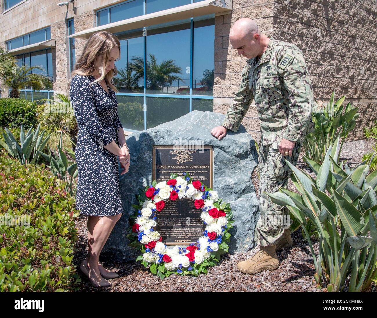 SAN DIEGO (May 27, 2021) Rear Adm. H.W. Howard III, Commander, Naval Special Warfare Command and his wife Sarah lay a wreath in observance of Memorial Day on the Extortion 17 Memorial. The Extortion 17 helicopter crash claimed the lives of 38 people, including 22 NSW personnel in Afghanistan Aug. 6, 2011. NSW is the nation’s premiere maritime special operations force that extends the Fleet and Joint Force's reach for collection and lethality, delivers all domain options to undermine our enemies’ confidence, and strengthens diplomatic leverage. Stock Photo