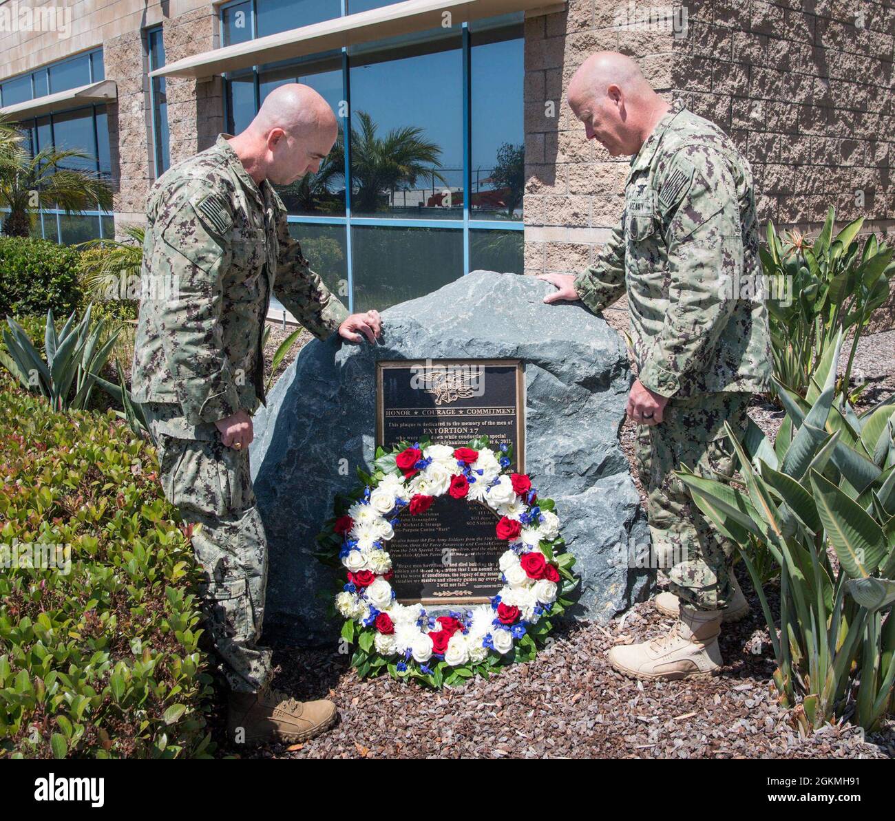 SAN DIEGO (May 27, 2021) Rear Adm. H.W. Howard III, Commander, Naval Special Warfare Command, left, and Naval Special Warfare Force Master Chief (SEAL) Bill King lay a wreath in observance of Memorial Day on the Extortion 17 Memorial. The Extortion 17 helicopter crash claimed the lives of 38 people, including 22 NSW personnel in Afghanistan Aug. 6, 2011. NSW is the nation’s premiere maritime special operations force that extends the Fleet and Joint Force's reach for collection and lethality, delivers all domain options to undermine our enemies’ confidence, and strengthens diplomatic leverage. Stock Photo