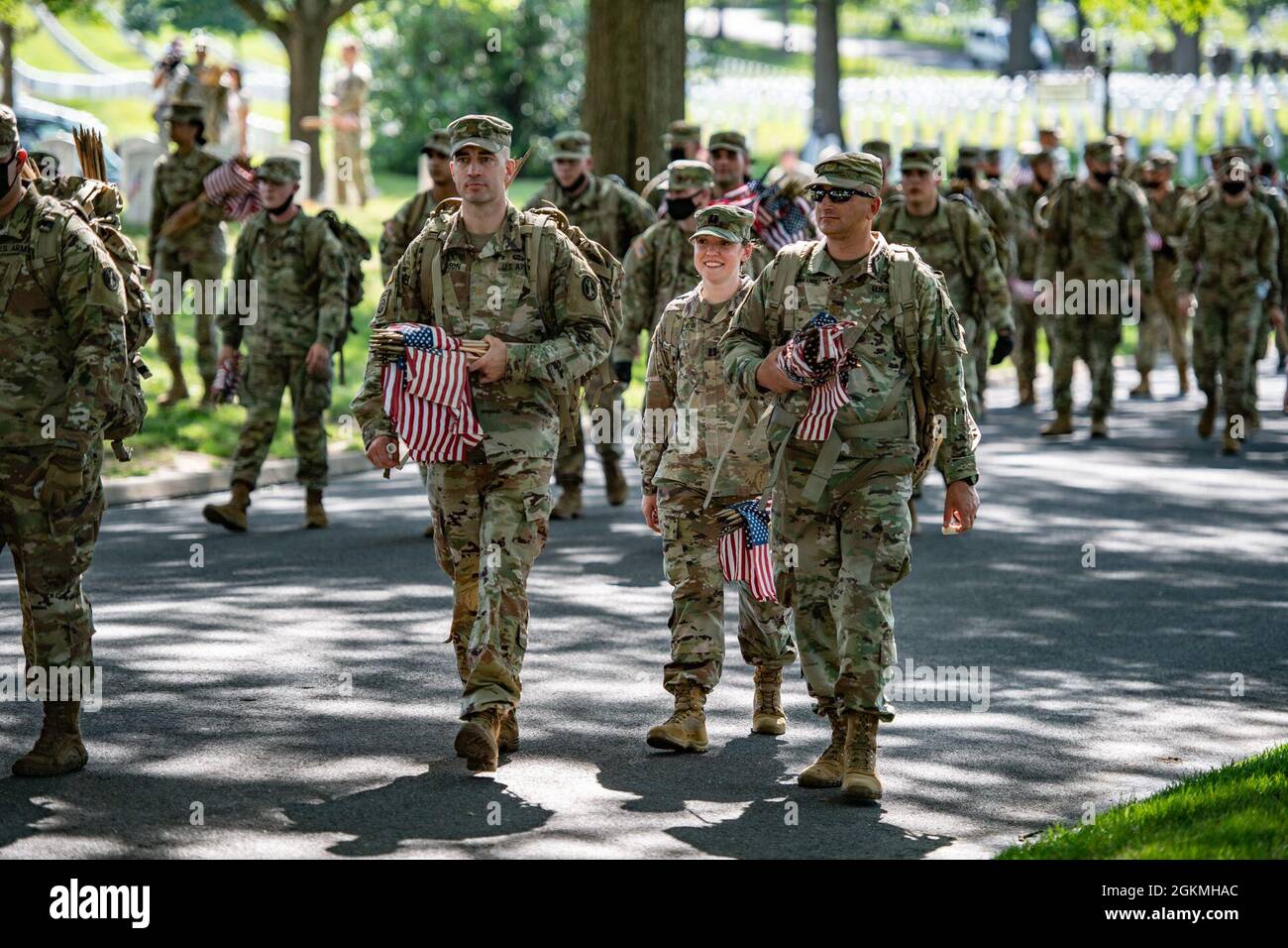 Soldiers from the U.S. Army 3d U.S. Infantry Regiment (The Old Guard), along with service members from all armed forces service branches, place over 265,000 U.S. flags at every gravesite, columbarium court column, and niche wall column as part of Flags-In at Arlington National Cemetery, Arlington, Virginia, May 27, 2021.    For more than 50 years, soldiers from The Old Guard have honored our nation’s fallen military heroes by placing U.S. flags at the gravesites of service members buried at both Arlington National Cemetery and the U.S. Soldiers’ and Airmen’s Home National Cemetery just prior t Stock Photo