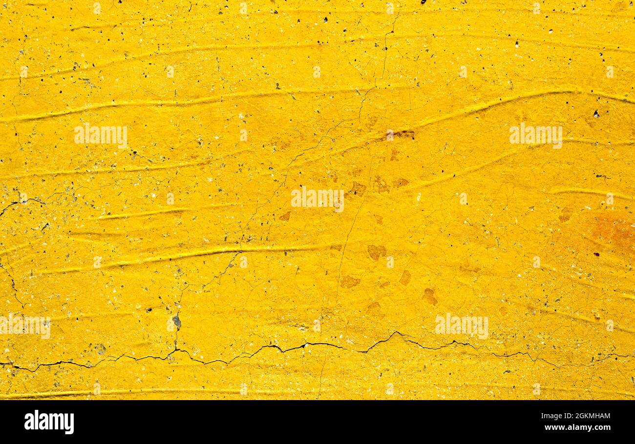 Yellow painted old dirty concrete wall texture or background Stock Photo