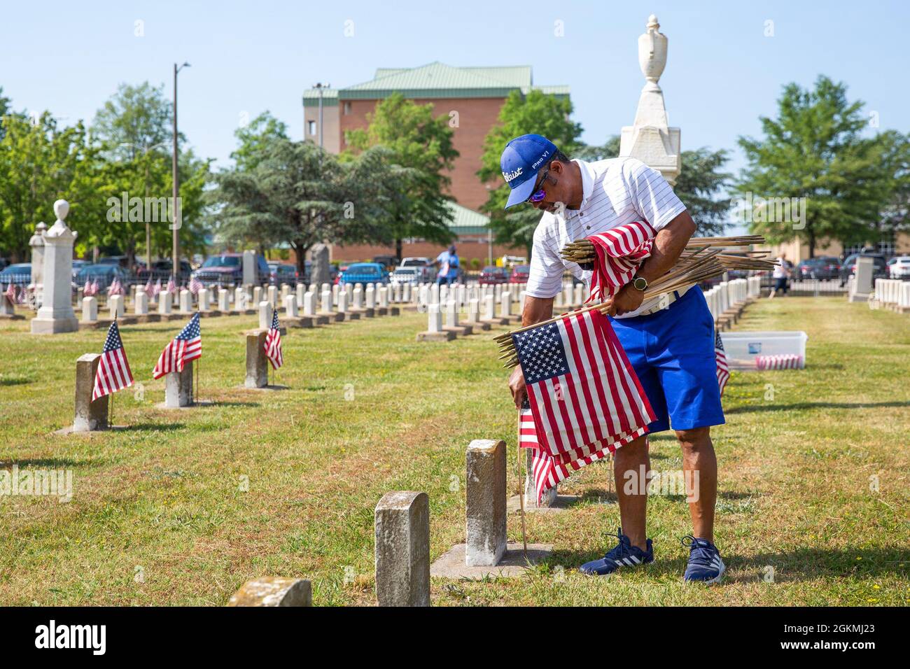 Naval Support Activity Hampton Roads Portsmouth Site Director Kenneth Pugh places flags on the graves of fallen service members during the annual flag placement ceremony at the Captain Ted Conaway Memorial Naval Cemetery in Naval Medical Center Portsmouth (NMCP) May 27. Stock Photo