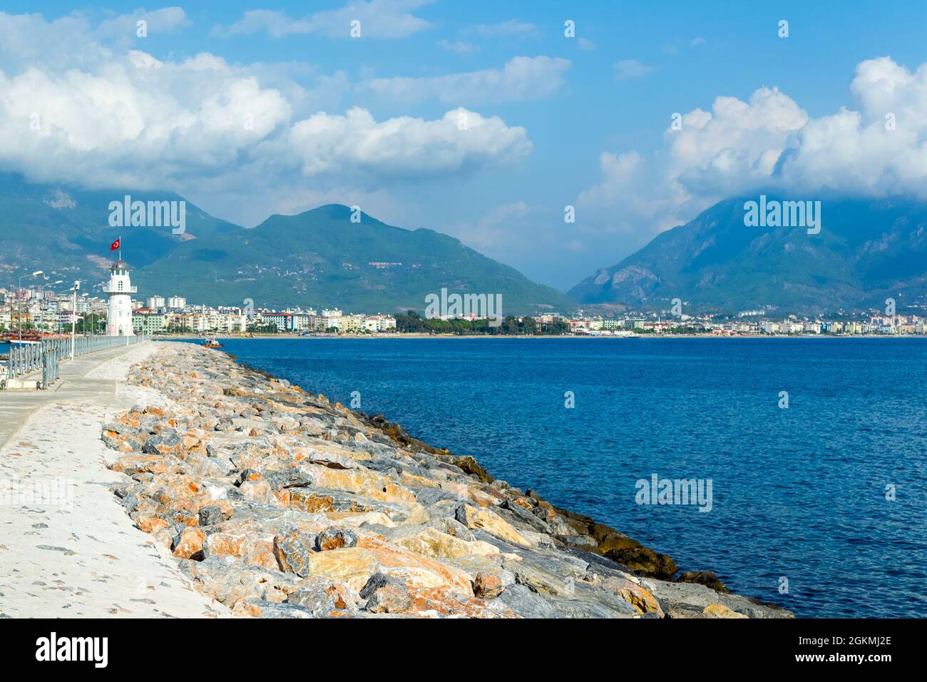Road to a lighthouse in the scenery of  amazing sky, clouds and mountains in the city of Alanya, Turkey. Stock Photo