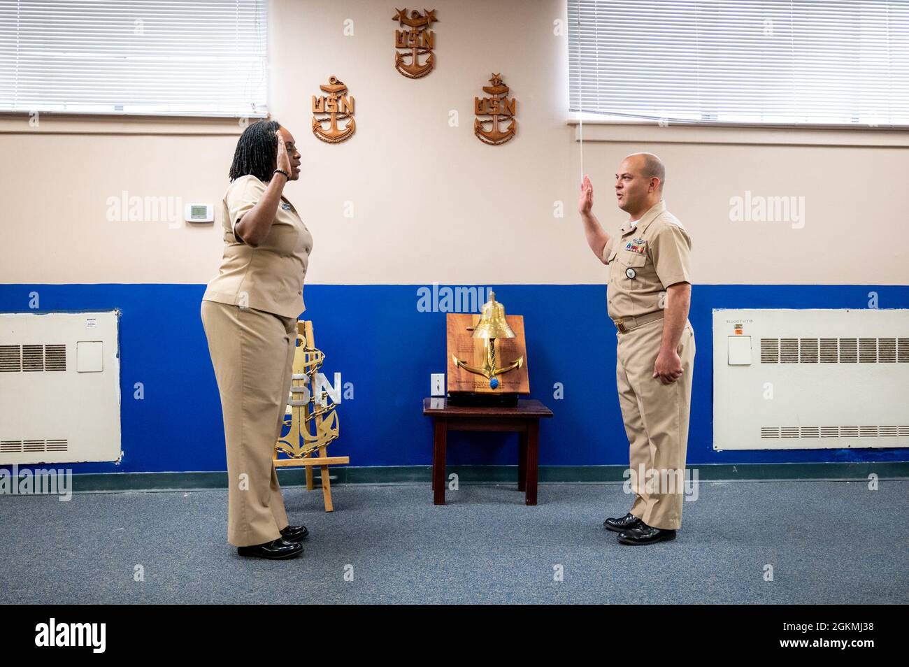 WASHINGTON, DC (May 27, 2021) – Lt. Takana Jefferson (left), Naval Support Activity Washington chaplain, administers the oath of enlistment for Chief Navy Counselor Eduardo Rivera (right) onboard Washington Navy Yard. Stock Photo