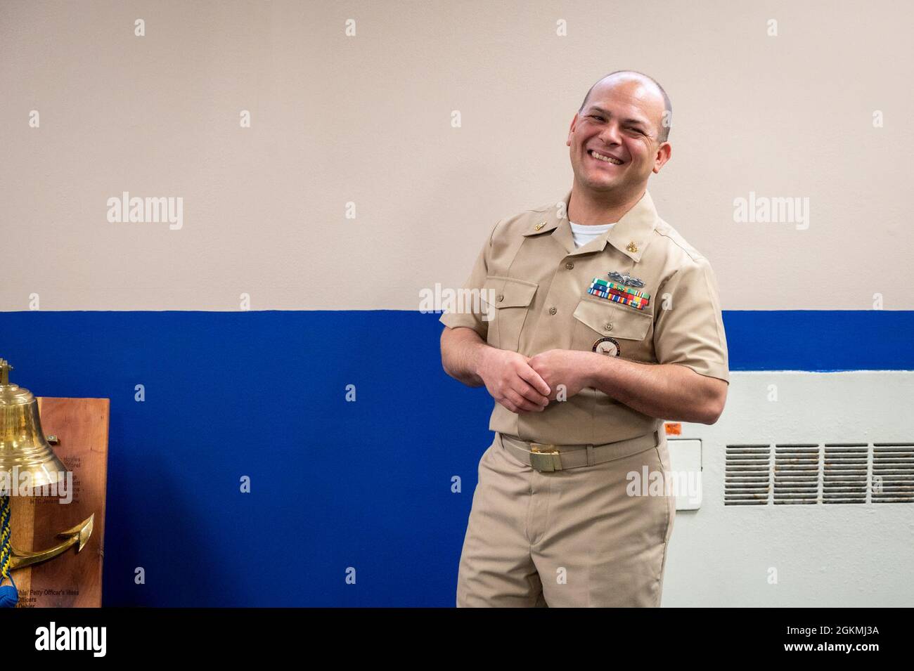 WASHINGTON, DC (May 27, 2021) – Chief Navy Counselor Eduardo Rivera laughs with his colleagues before a reenlistment ceremony held in his honor onboard Washington Navy Yard. Stock Photo