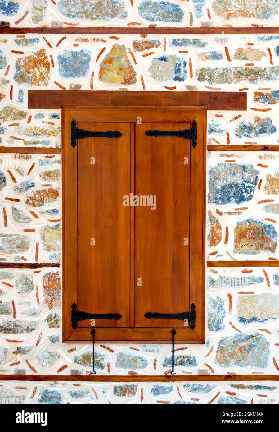 Wooden window shutters closed on aged stone wall Stock Photo - Alamy