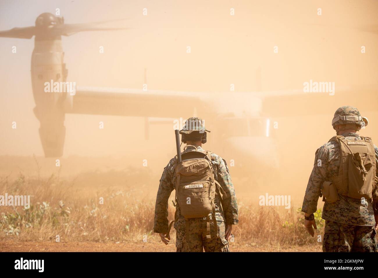 U.S. Marine Corps Staff Sgt. Benjamin Dampier, left, an air traffic controller, and Cpl. Ty Cochrane, an air support operations operator, both with Marine Medium Tiltrotor Squadron 363 (Reinforced), Marine Rotational Force – Darwin, watch an MV-22B Osprey land at Point Fawcett, NT, Australia during exercise Crocodile Response, May 27, 2021. Exercise Crocodile Response tested the ability of MRF-D and the Australian Defence Force to provide disaster relief in the Indo-Pacific region. The rotational deployment of U.S. Marines affords a combined training opportunity with Australia and improves coo Stock Photo