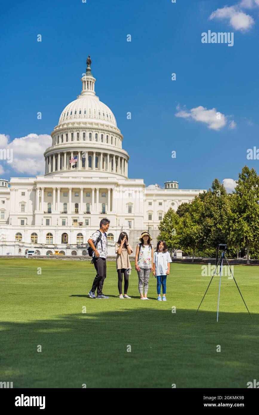 Washington DC, USA - August 14, 2021: Asian tourists taking pictures in front of US Capitol building. Stock Photo