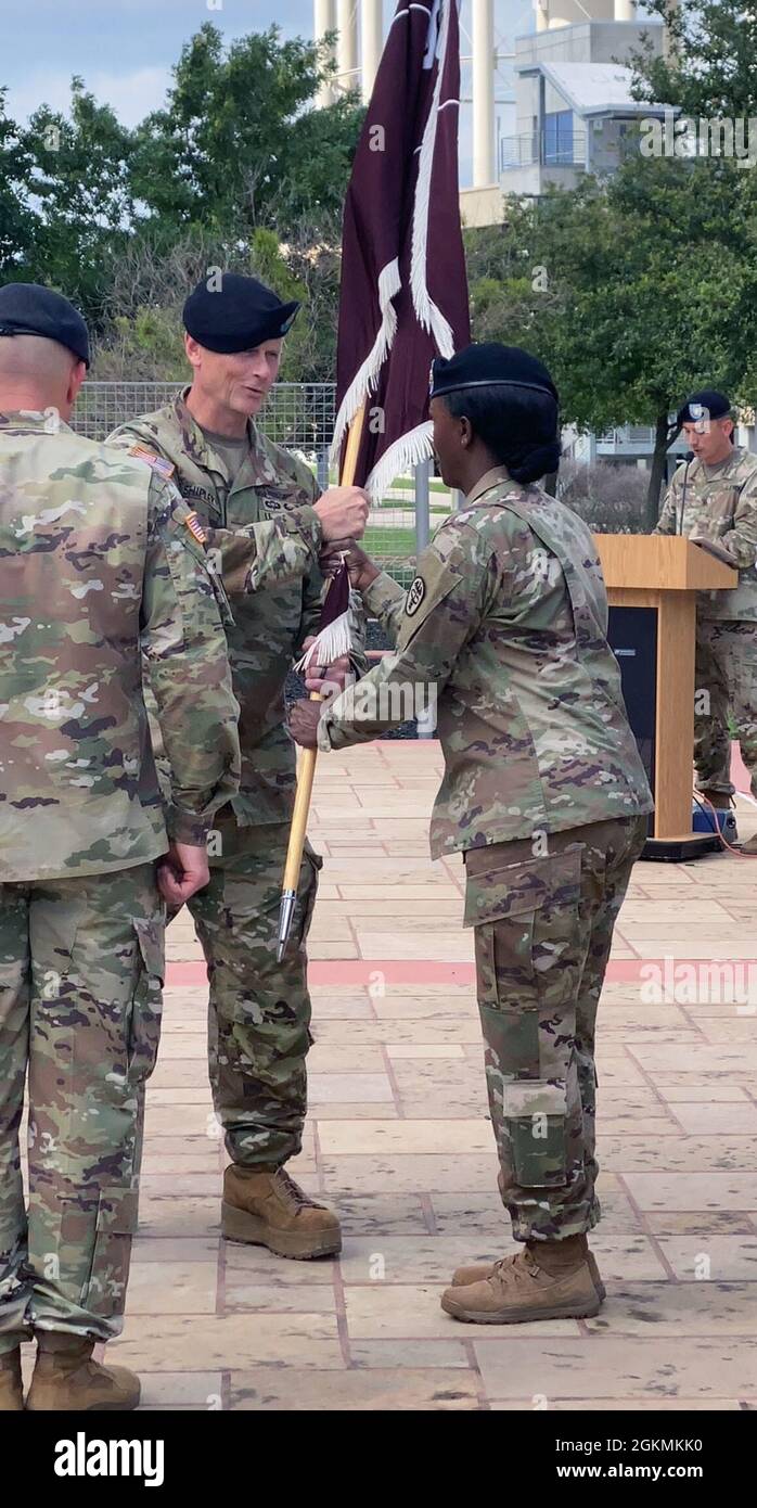 Incoming Troop Commander Lt. Col. Jody Shipley passes the guidon to Command Sgt. Maj. Stephanie Bellinger, Troop Command's senior enlisted advisor, signifying his assumption of command during a ceremony at Carl R. Darnall Army Medical Center May 28. Stock Photo
