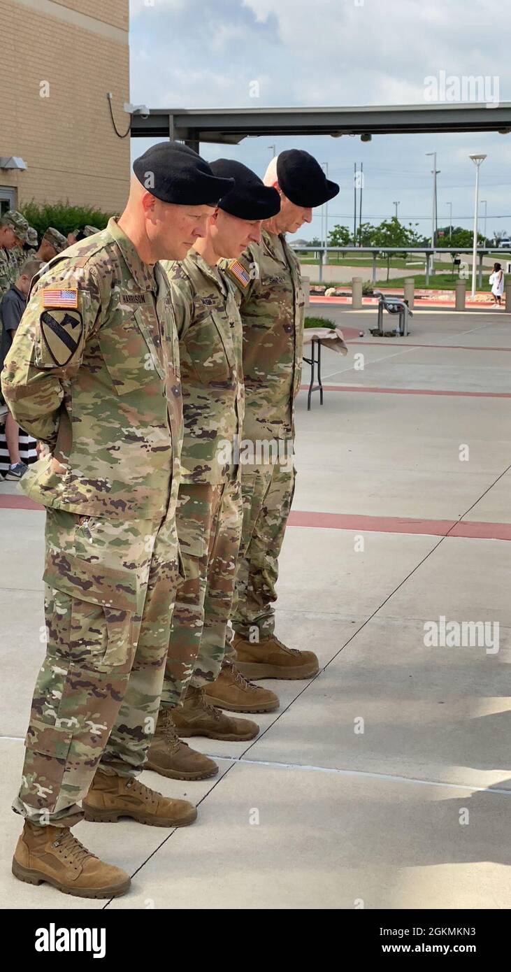 Lt. Col. Scott Harrison, outgoing troop commander; Col. Richard Malish, commander of Carl R. Darnall Army Medical Center; Lt. Col. Jody Shipley pause for chaplain's blessing during CRDAMC's Troop Command change of command ceremony on Prichard Field May 28. Stock Photo
