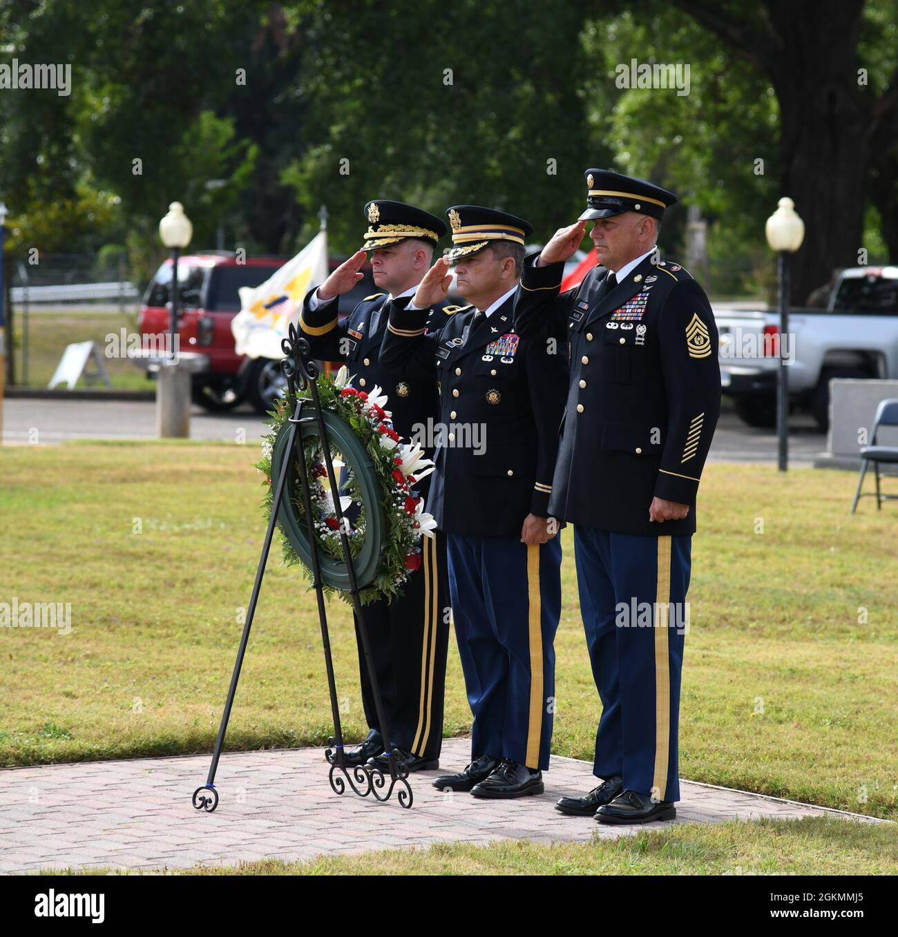 U.S. Army Maj. Gen. David J. Francis, U.S. Army Aviation Center of Excellence and Fort Rucker commander, is joined by Chief Warrant Officer 5 Myke Lewis, chief warrant officer of the aviation branch, and Command Sgt. Maj. James Wilson, aviation branch command sergeant major, to emplace a wreath and render honors while Taps is played at Veterans Park during a Memorial Day Ceremony at Fort Rucker, Alabama, May 28, 2021. Stock Photo