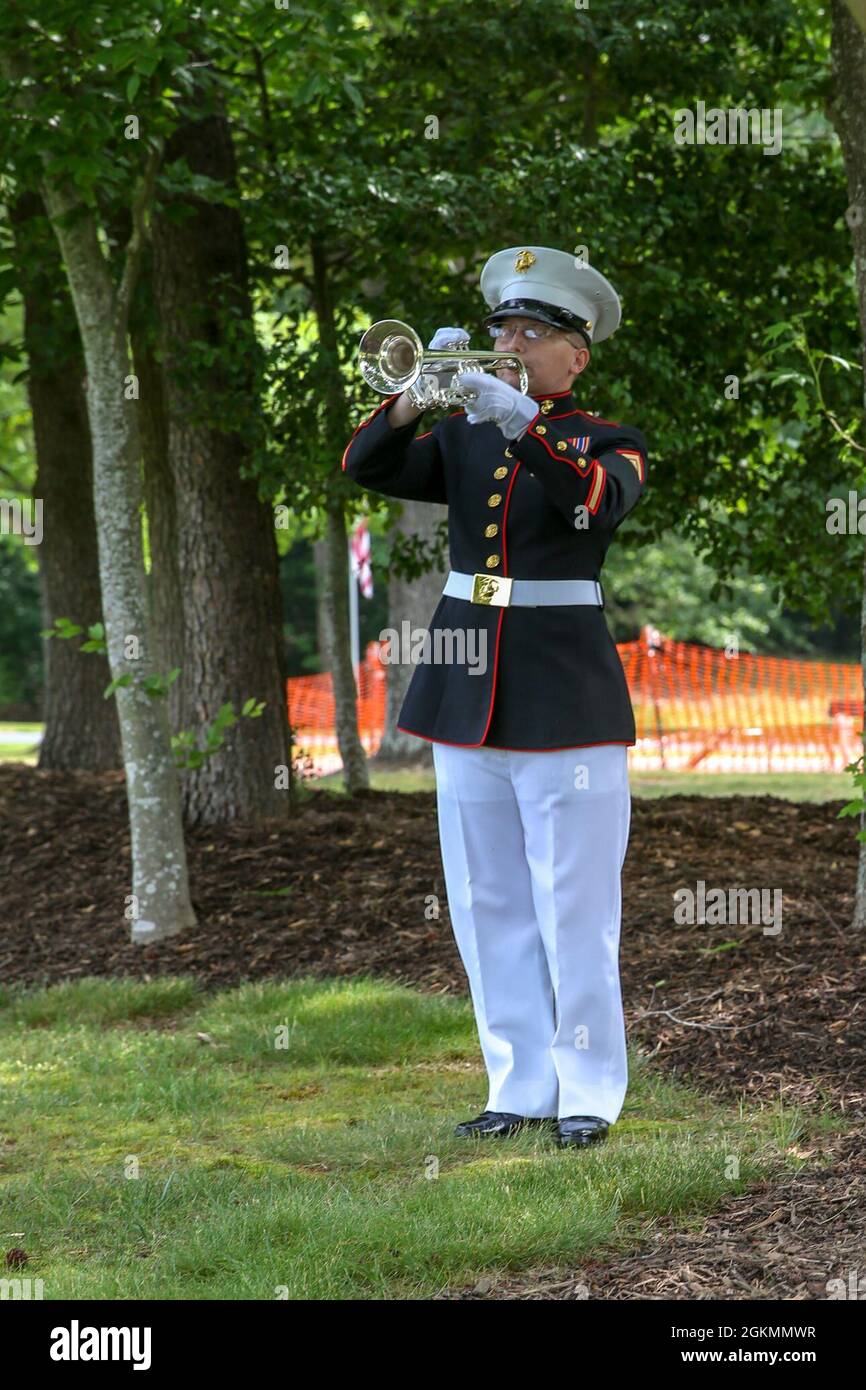 U.S. Marine Corps Sgt. Tiffany A. Woda, trumpet instrumentalist, Quantico  Marine Corps Band, plays taps at Quantico National Cemetery in Triangle,  Virginia, May 28, 2021. Taps is played during the wreath laying
