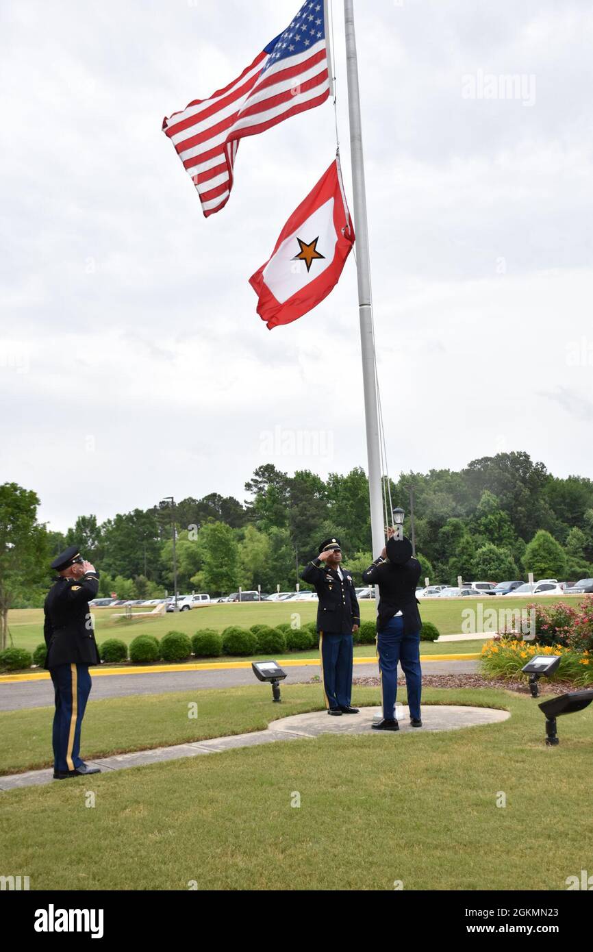 U.S. Army Space and Missile Defense Soldiers raise the Gold Star Flag, May 28, at the command’s Redstone Arsenal, Alabama, headquarters to honor families who lost loved ones serving in the armed services. Stock Photo