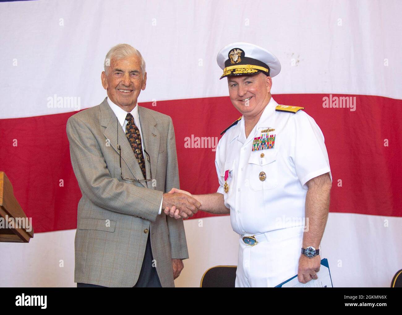 210528-N-TY704-1236 SAN DIEGO (May 28, 2021) Capt. (Ret.) Paul D. Stephenson awards Rear Adm. Timothy Kott, Commander, Carrier Strike Group (CSG) ONE, the Legion of Merit Award during a change of command ceremony, May 28, 2021. Carrier Strike Group ONE leads the Carl Vinson Carrier Strike Group with a team of ships, aircraft, and more than 60,000 Sailors, capable of carrying out missions around the globe. Vinson is currently pier side in its homeport of San Diego. Stock Photo