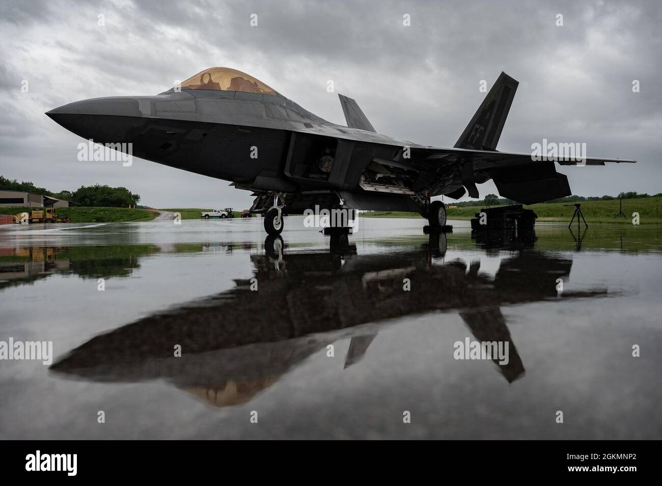 An F-22 Raptor sits in a rainstorm after arriving for an F-22 Raptor Demo Team demonstration at the Westmoreland County Airshow in Latrobe, Pennsylvania, May 28, 2021. Due to cloud cover, the F-22 demonstration was limited to a modified low-show to provide the most maneuvers for spectators. Stock Photo
