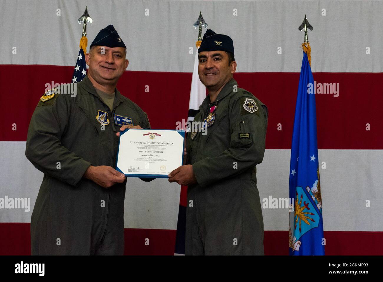 Col. John Gonzales, 51st Fighter Wing commander, left, awards the ...