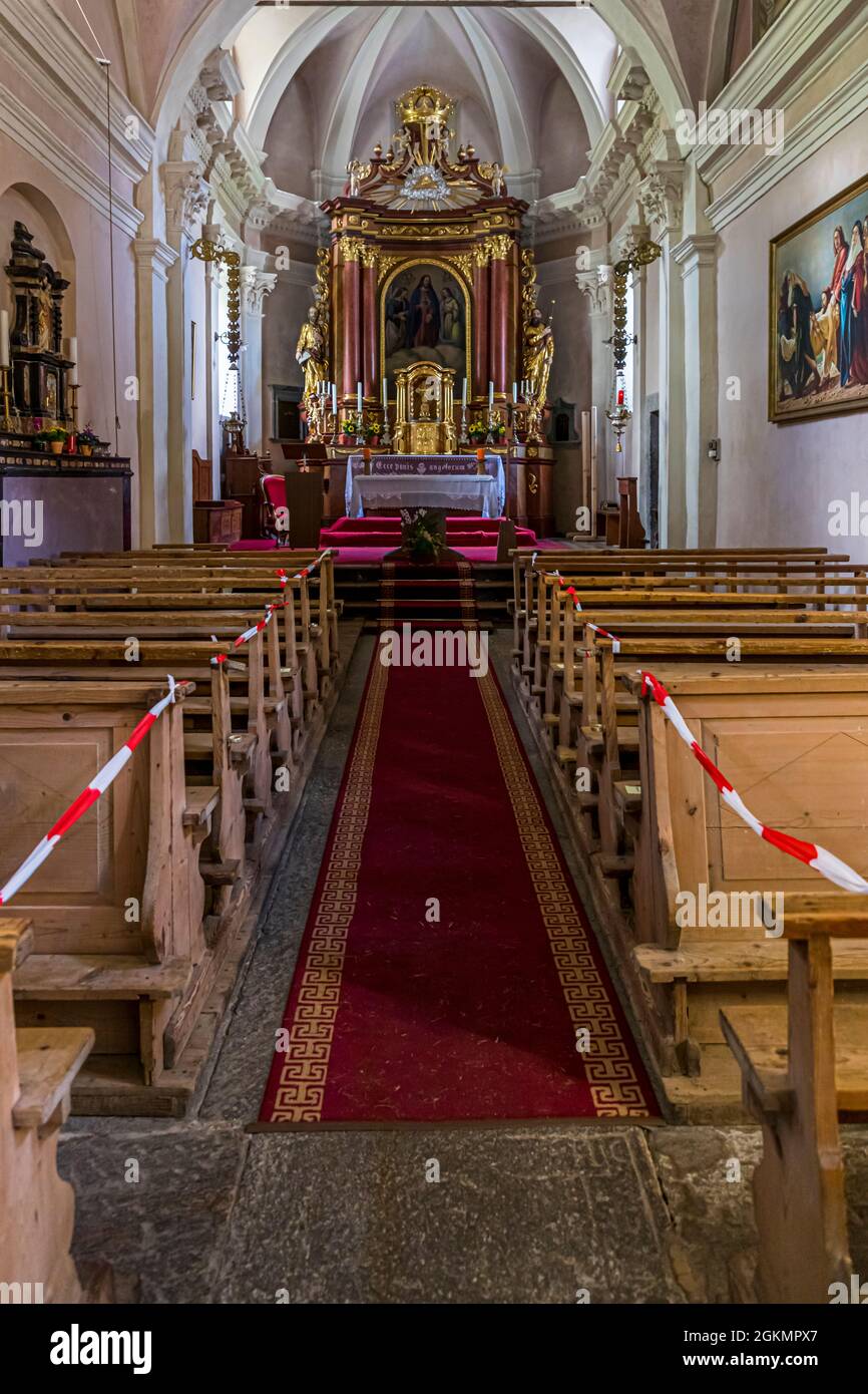 In the village church of St. James and St. Christopher of Bosco Gurin, the rows of seats have distance bands because of the covid pandemic, Circolo della Rovana, Switzerland Stock Photo