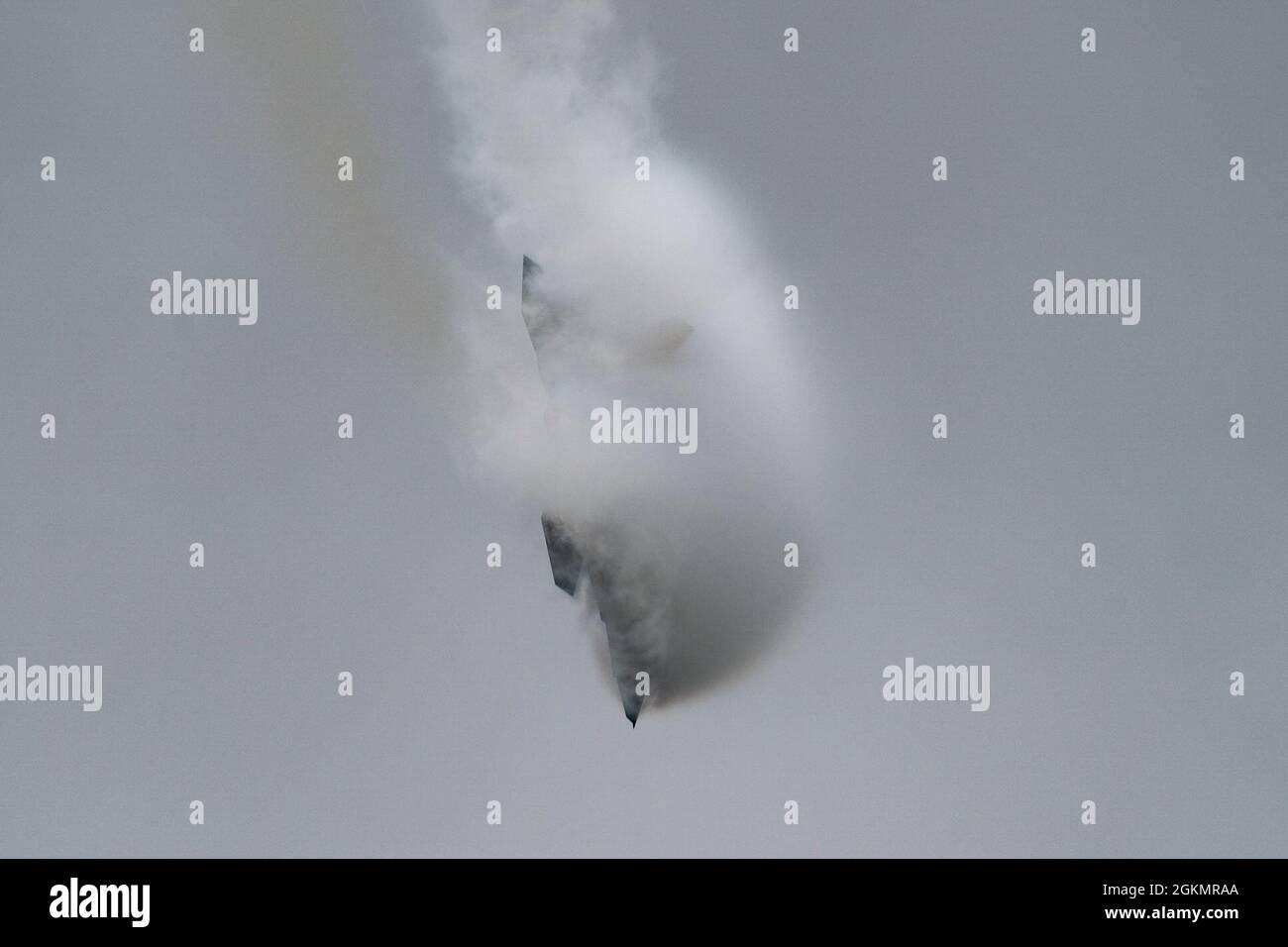U.S. Air Force Maj. Josh Gunderson, F-22 Raptor Demo Team commander, performs a Tactical Pitch during a demonstration at the Westmoreland County Airshow in Latrobe, Pennsylvania, May 29, 2021. The cloud that forms across the aircraft is due to a change in air pressure across the wing causing the moisture to condense into a visible vapor cloud. Stock Photo