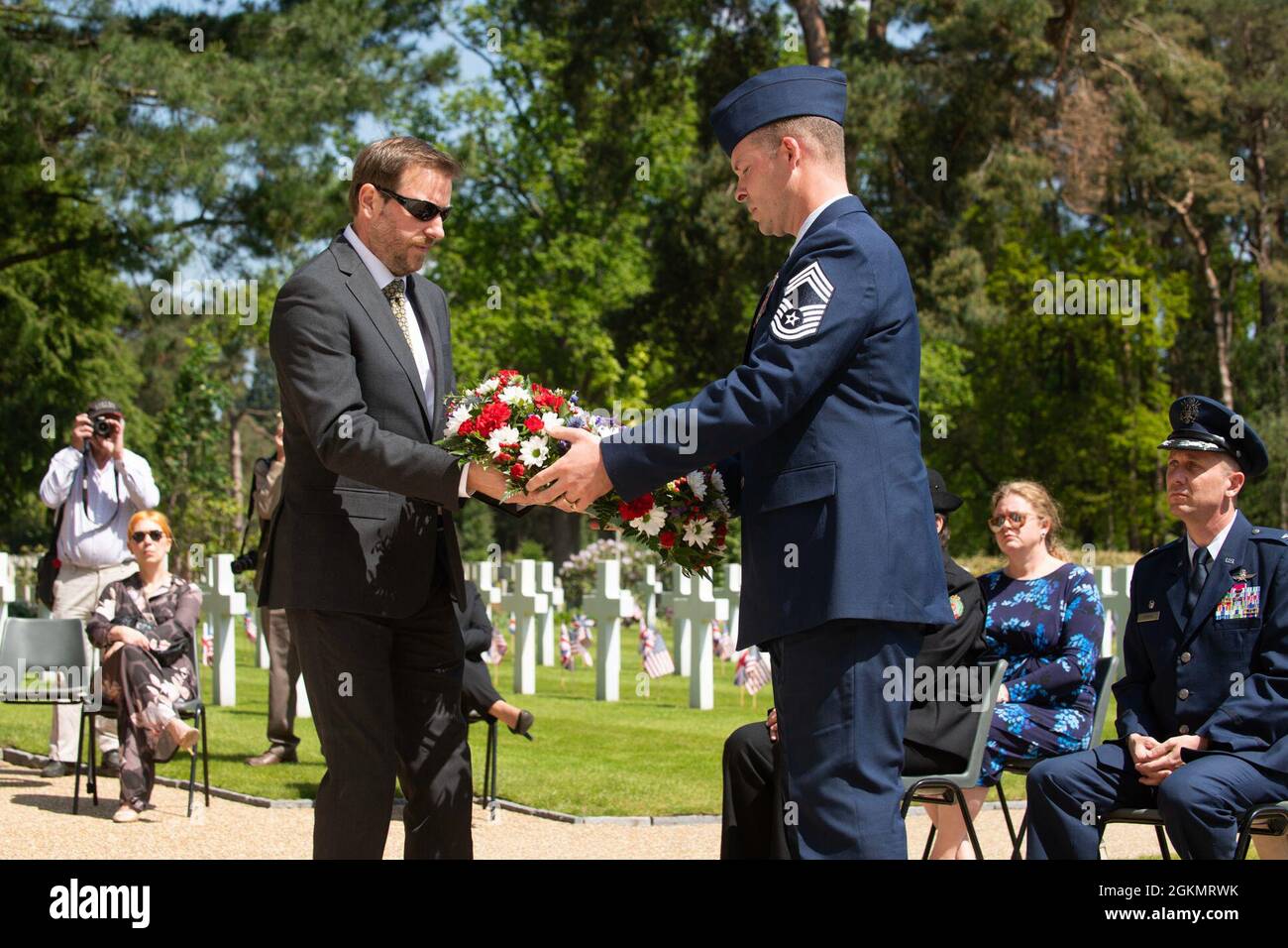 U.S. Air Force Chief Master Sgt. Michael Venning, 422nd Air Base Group superintendent, receives a memorial wreath at a 2021 Memorial Day ceremony at the Brookwood American Military Cemetery, England, May 30, 2021. Memorial Day is one of our Nation's most solemn occasions. It serves as a chance to pause, reflect, and honor the women and men who gave the last full measure defending our Nation and our democratic ideals. Stock Photo