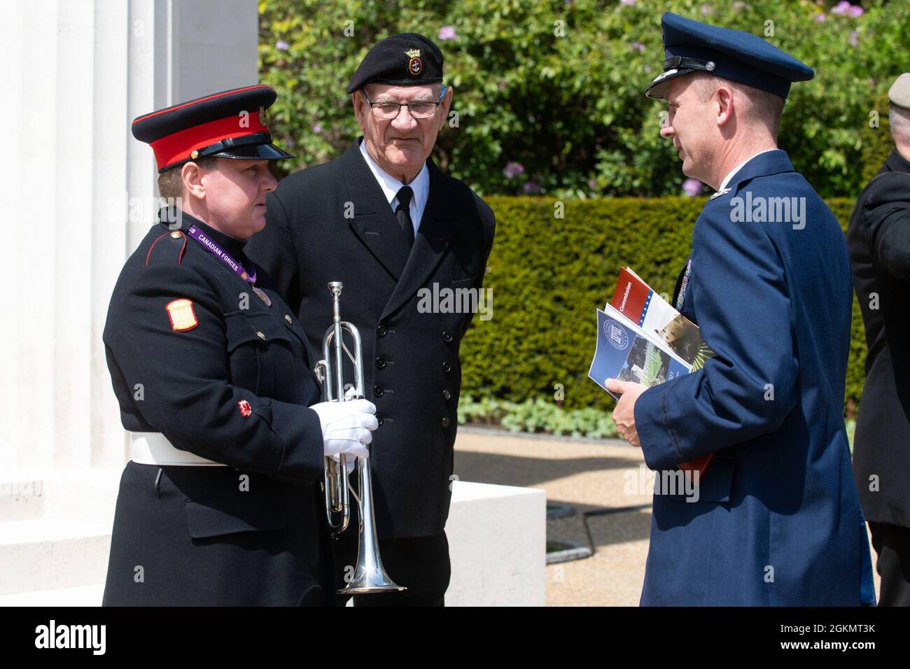 U.S. Air Force Col. Jon Hannah, right, 422nd Air Base Group commander, talks with Bugler Heidi Watkins, left, Canadian High Commission, UK, at a 2021 Memorial Day ceremony at the Brookwood American Military Cemetery, England, May 30, 2021. Memorial Day is one of our Nation's most solemn occasions. It serves as a chance to pause, reflect, and honor the women and men who gave the last full measure defending our Nation and our democratic ideals. Stock Photo
