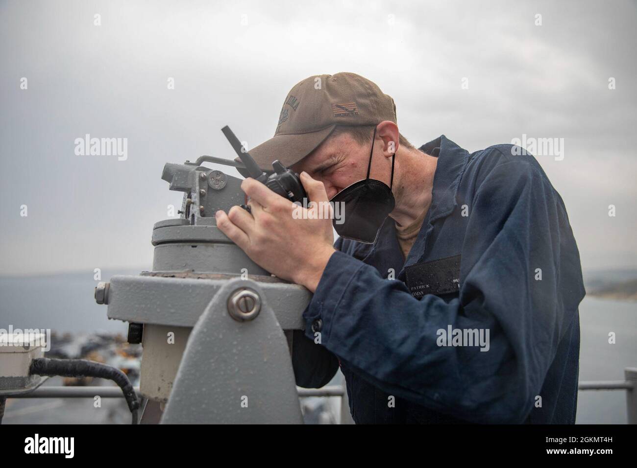 210530-N-LN075-1044  MEDITERRANEAN SEA (May 30, 2021) Quartermaster Seaman Patrick Buza, assigned to the Wasp-class amphibious assault ship USS Iwo Jima (LHD 7), gathers the bearings of surface contacts using a telescopic alidade during a sea and anchor evolution, May 30, 2021. Iwo Jima is underway in the Mediterranean Sea with Amphibious Squadron 4 and the 24th Marine Expeditionary Unit (MEU) as part of the Iwo Jima Amphibious Ready Group. Stock Photo