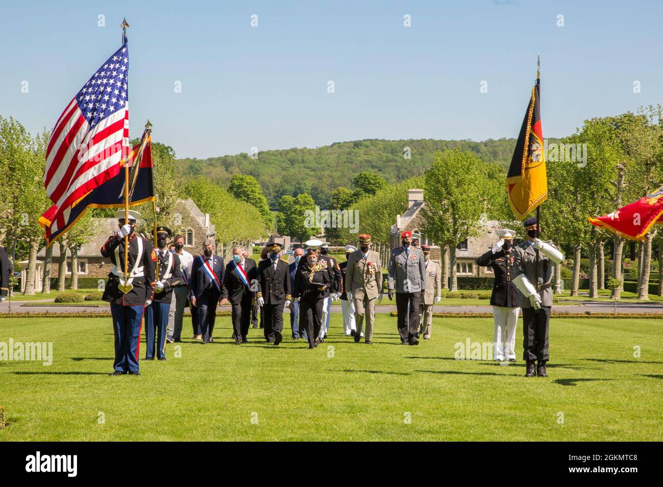 The official party members walk to their seats during a ceremony at Aisne-Marne American Cemetery in Belleau, France, May 30, 2021. The ceremony was held Memorial Day weekend in commemoration of the 103rd anniversary of the battle of Belleau Wood, conducted to honor the legacy of service members who gave their lives in defense of the United States and European allies.  U.S. Marines and Sailors from Marine Corps Forces Europe and Africa, 5th Marine Regiment, 6th Marine Regiment, 1st Marine Division band, U.S. Soldiers from the Army 26th Infantry Division, 2nd Infantry Division representatives, Stock Photo