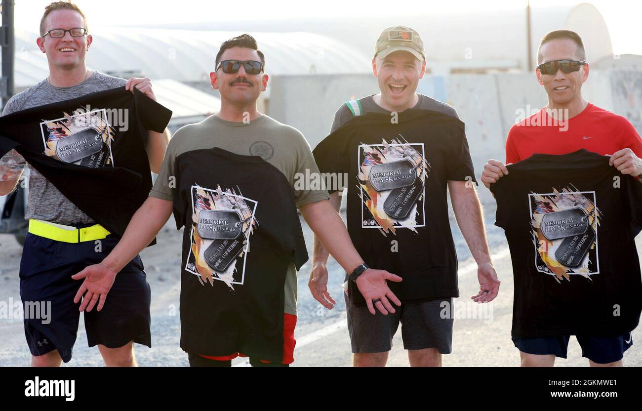 From left, Capt. Stephen Schneider, Capt. Philippe Vasquez, Capt. Daniel Burns and Maj. Paul Lo pose for a photo at the end of the Memorial Day 5K Run/Walk at Camp Buehring, Kuwait. Stock Photo