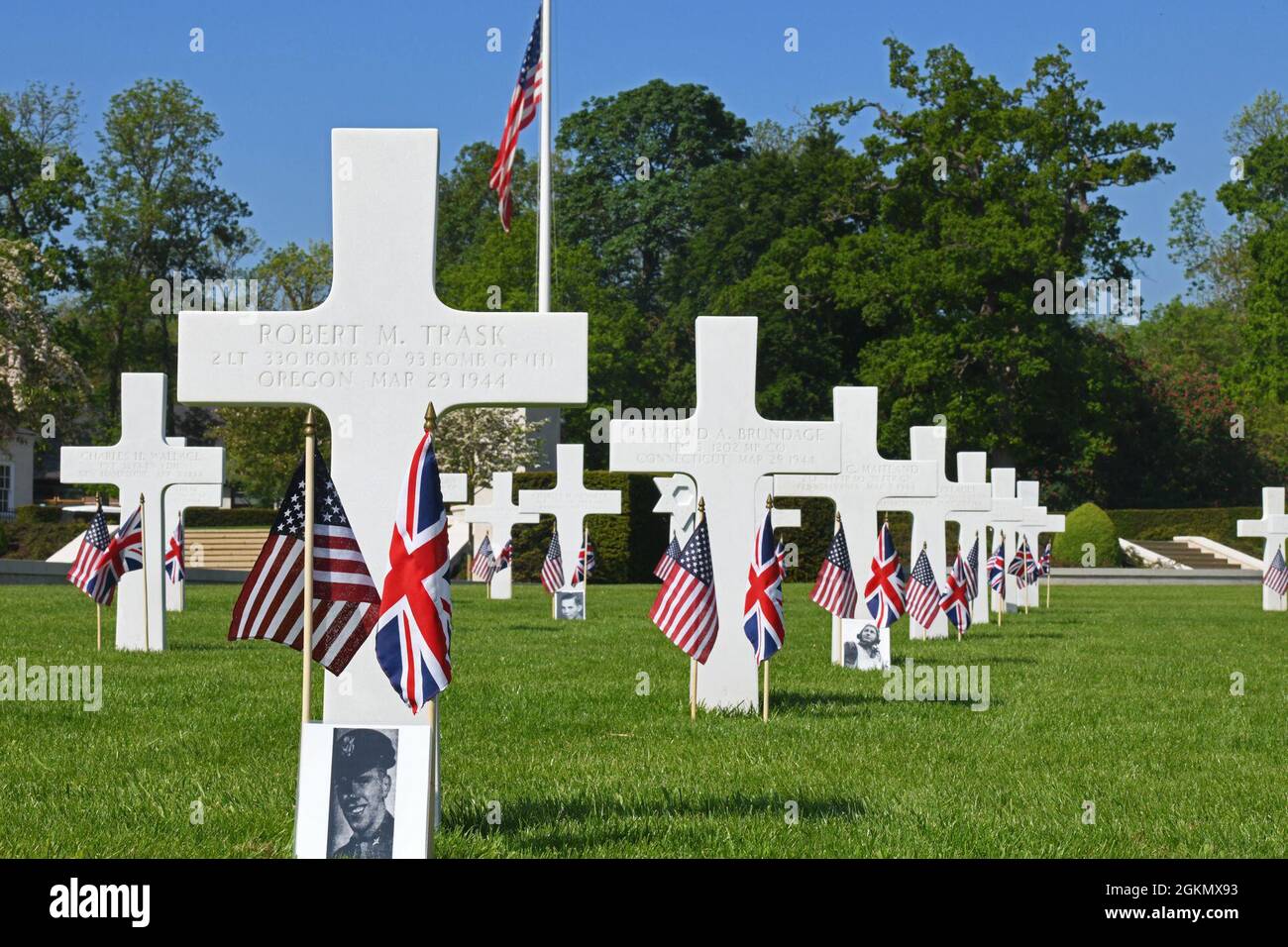 Grave plots are lined with flags and photos of the fallen prior to a