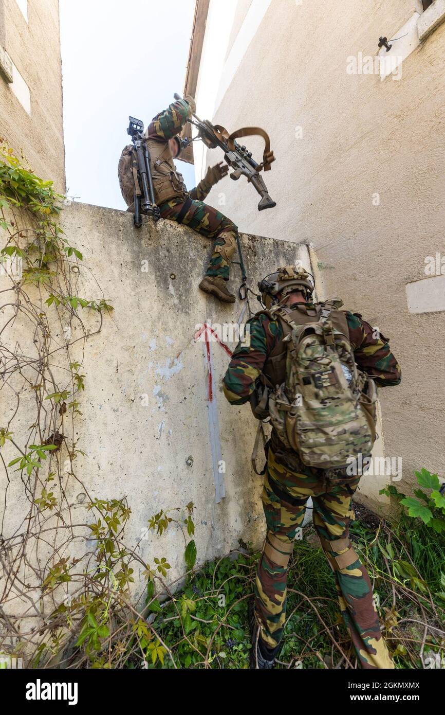 A Belgian Special Operations Forces Sniper Team Climbs A Wall During An