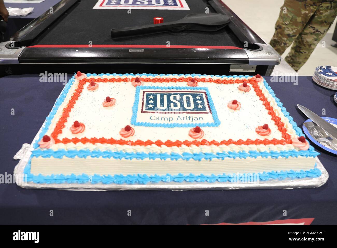 Uso Kuwait USO Camp Arifjan serves a cake as part of their re-opening ceremony ...