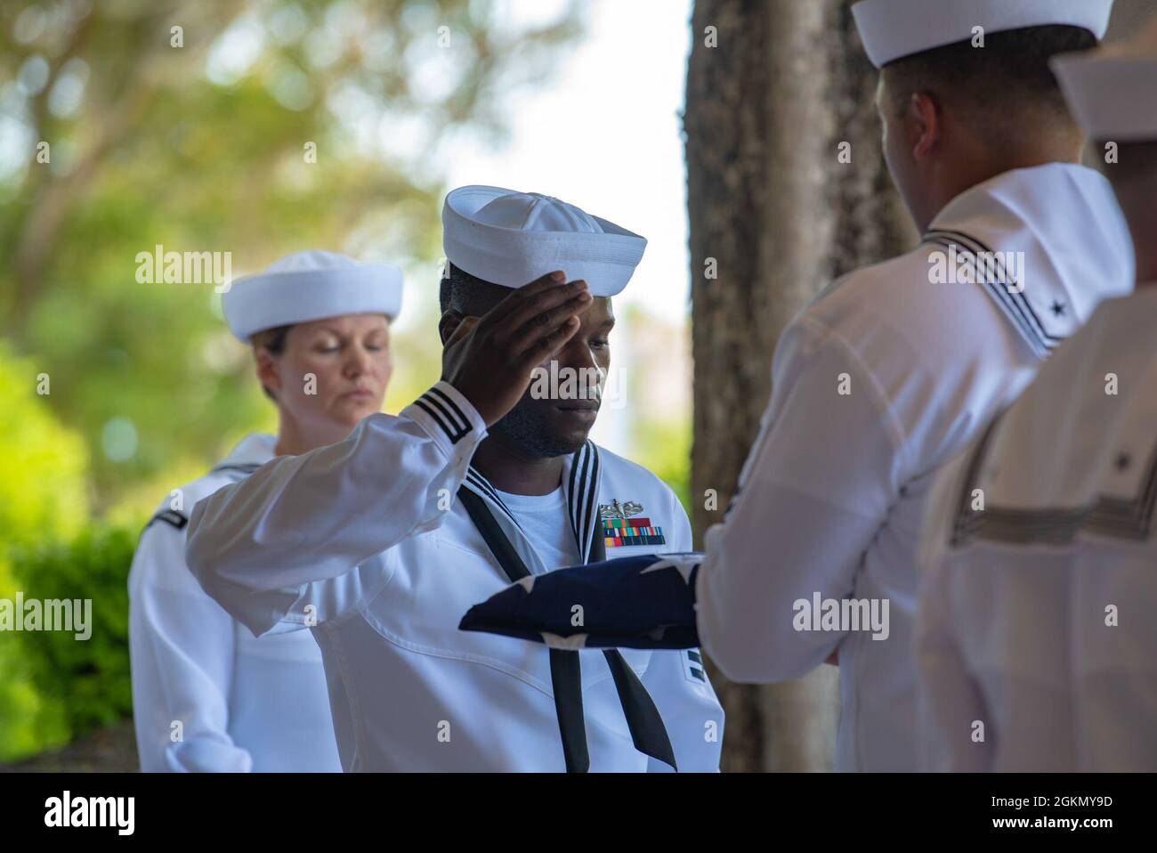 Sailors assigned to Navy Region Hawaii and the Defense POW/MIA Accounting Agency (DPAA) conduct a funeral for U.S. Navy Bandmaster James B. Booe, 42, of Veedersburg, Indiana, at the National Memorial Cemetery of the Pacific, Honolulu, Hawaii, June 1, 2021. Booe was assigned to the USS Oklahoma which sustained fire from Japanese aircraft and multiple torpedo hits causing the ship to capsize and resulted in the deaths of more than 400 crew members on Dec. 7, 1941, at Ford Island, Pearl Harbor. Booe was recently identified through DNA analysis by the DPAA forensic laboratory and laid to rest with Stock Photo