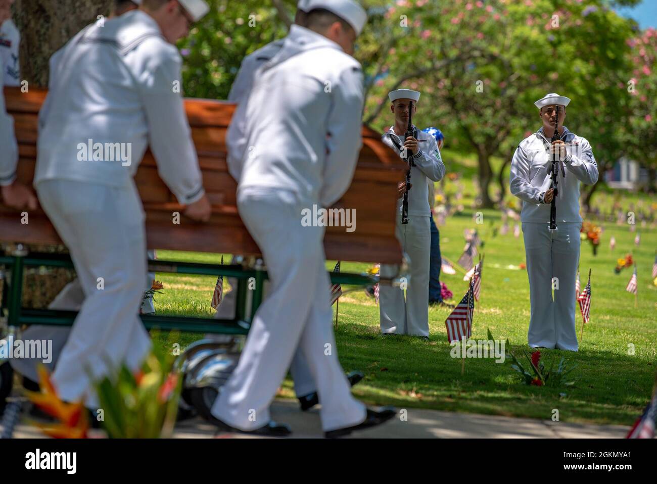 Sailors assigned to Navy Region Hawaii and the Defense POW/MIA Accounting Agency (DPAA) conduct a funeral for U.S. Navy Bandmaster James B. Booe, 42, of Veedersburg, Indiana, at the National Memorial Cemetery of the Pacific, Honolulu, Hawaii, June 1, 2021. Booe was assigned to the USS Oklahoma which sustained fire from Japanese aircraft and multiple torpedo hits causing the ship to capsize and resulted in the deaths of more than 400 crew members on Dec. 7, 1941, at Ford Island, Pearl Harbor. Booe was recently identified through DNA analysis by the DPAA forensic laboratory and laid to rest with Stock Photo