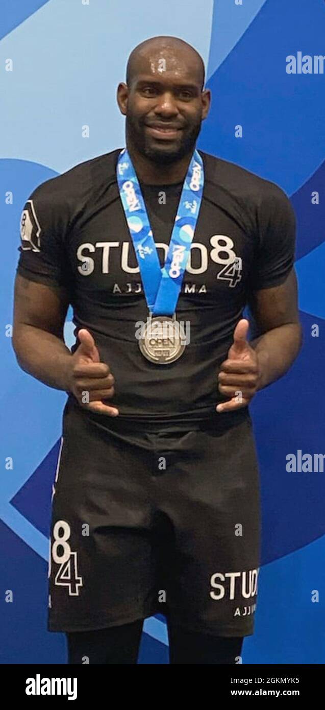 Staff Sgt. Dominick Williams of First Army’s 174th Infantry Brigade stands draped in the second-place medal he won in the Master 1 Ultra-Heavyweight black belt category at the International Brazilian Jiu-Jitsu Federation Open Championship in Houston. Stock Photo