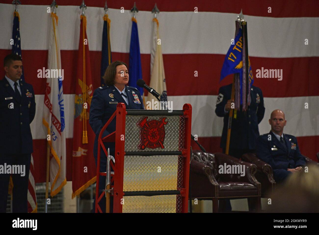 U.S. Air Force Col. Angelina Maguinness, 17th Training Group commander, addresses the audience during the change of command ceremony at the Louis F. Garland Department of Defense Fire Academy High Bay on Goodfellow Air Force Base, Texas, June 1, 2021. Maguinness welcomed the 312th Training Squadron incoming commander, Maj. Samuel Logan, and thanked the 312th TRS outgoing commander, Lt. Col. Kevin Boss, for his hard work and dedication. Stock Photo