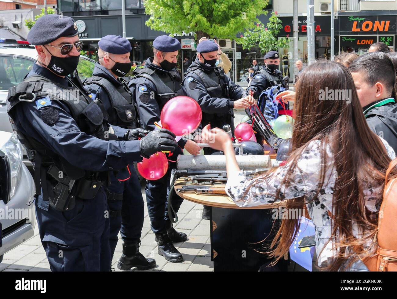 A Kosovo Police officer gives a balloon to a child during an observance of  International Children's Day in Ferizaj/Urosevac, Kosovo, on June 1, 2021.  The U.S. Kilo 21 Liaison Monitoring Team, based