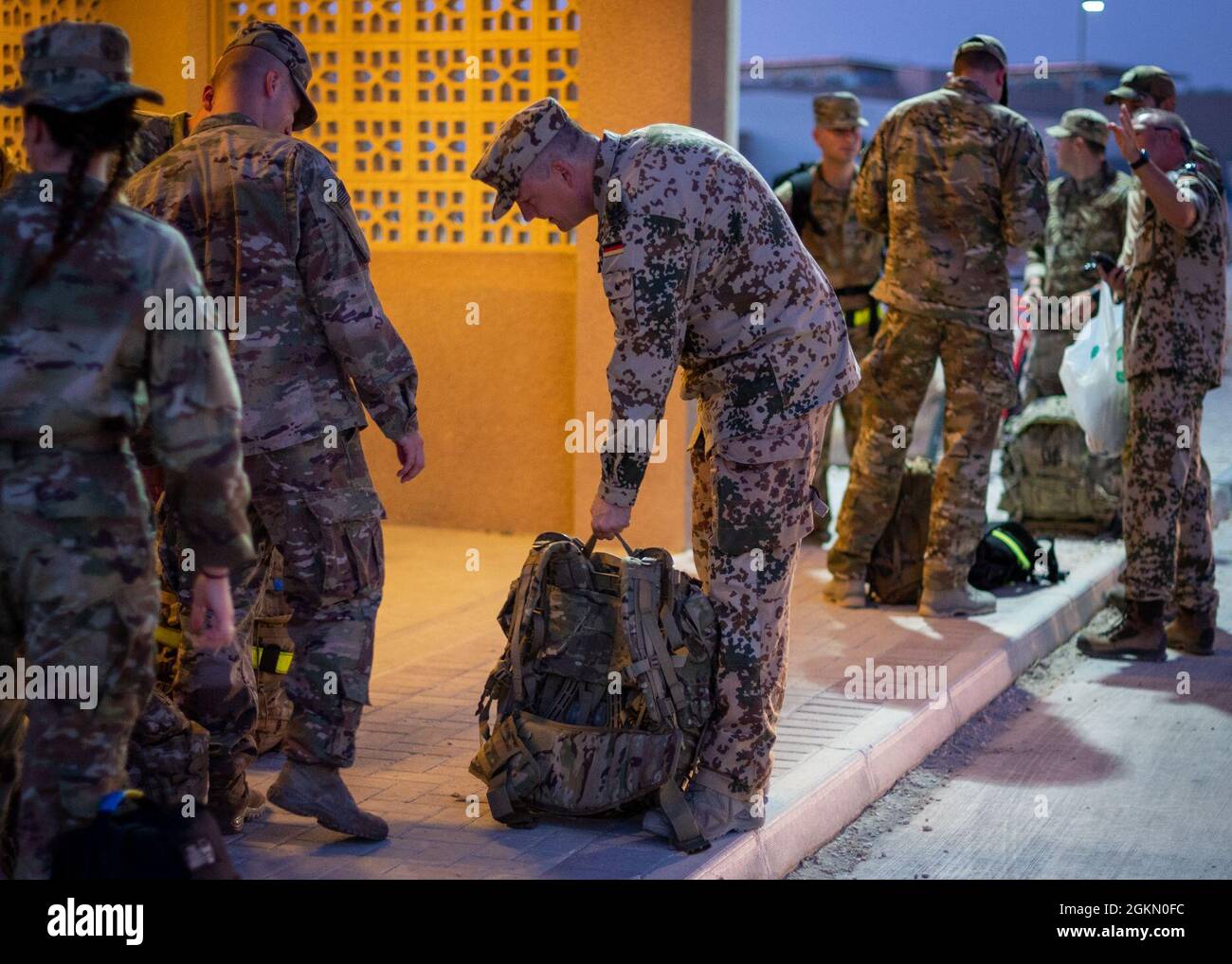 A member of the U.S. Air Forces Central German detachment weighs a ruck pack before the ruck march event as a part of the German Armed Forces Proficiency Badge competition June 1, 2021, at Al Udeid Air Base, Qatar. The ruck packs had to weigh a certain amount to qualify by the standards set forth for award of the GAFPB. Stock Photo