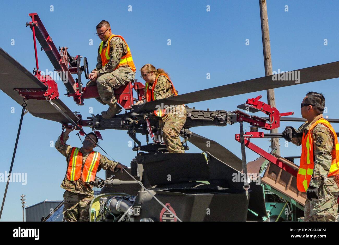 Soldiers assigned to 46th Aviation Support Battalion, 16th Combat Aviation Brigade, prepare an AH-64 attack helicopter for shipment at the Port of Tacoma, Wash., on Jun. 1, 2021.  The unit was preparing aircraft and equipment to be loaded onto a vessel for transport to a training exercise. Stock Photo