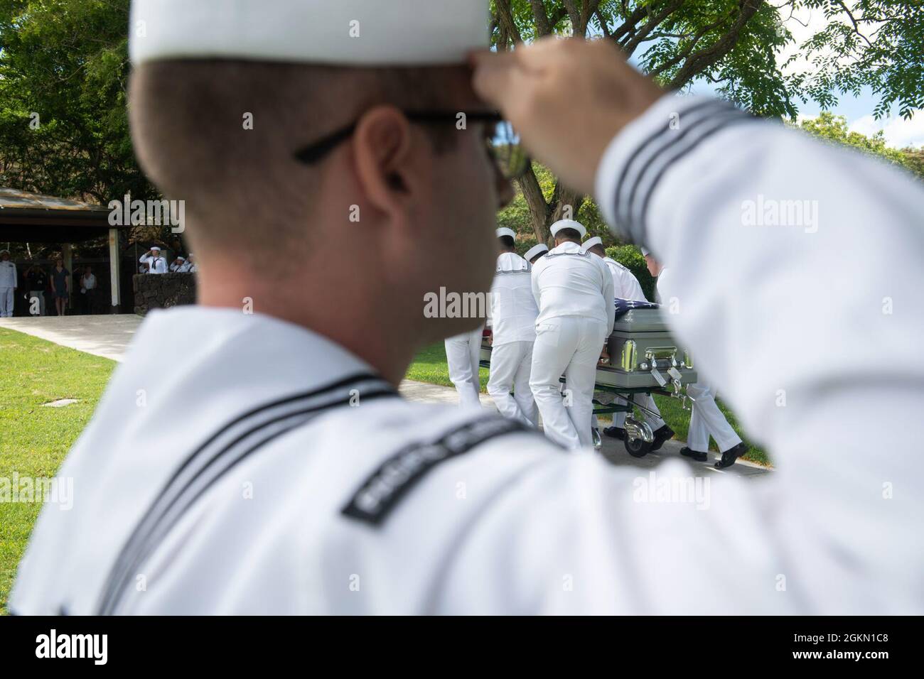 Sailors assigned to Navy Region Hawaii and the Defense POW/MIA Accounting Agency (DPAA) conduct a funeral for U.S. Navy Gunner’s Mate 3rd Class Shelby Treadway, 25, of Manchester, Kentucky, at the National Memorial Cemetery of the Pacific, Honolulu, Hawaii, June 2, 2021. Treadway was assigned to the USS Oklahoma, which sustained fire from Japanese aircraft and multiple torpedo hits causing the ship to capsize and resulted in the deaths of more than 400 crew members on Dec. 7, 1941, at Ford Island, Pearl Harbor. Treadway was recently identified through DNA analysis by the DPAA forensic laborato Stock Photo