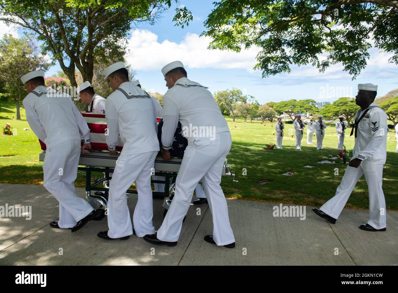 Sailors assigned to Navy Region Hawaii and the Defense POW/MIA Accounting Agency (DPAA) conduct a funeral for U.S. Navy Gunner’s Mate 3rd Class Shelby Treadway, 25, of Manchester, Kentucky, at the National Memorial Cemetery of the Pacific, Honolulu, Hawaii, June 2, 2021. Treadway was assigned to the USS Oklahom,a which sustained fire from Japanese aircraft and multiple torpedo hits causing the ship to capsize and resulted in the deaths of more than 400 crew members on Dec. 7, 1941, at Ford Island, Pearl Harbor. Treadway was recently identified through DNA analysis by the DPAA forensic laborato Stock Photo