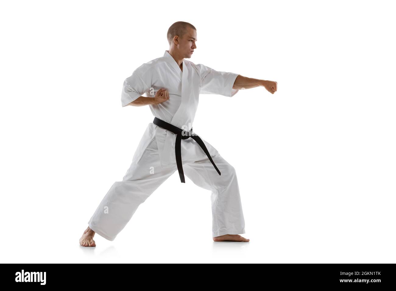 Fulllength portrait of caucasian sportsman standing in punch pose