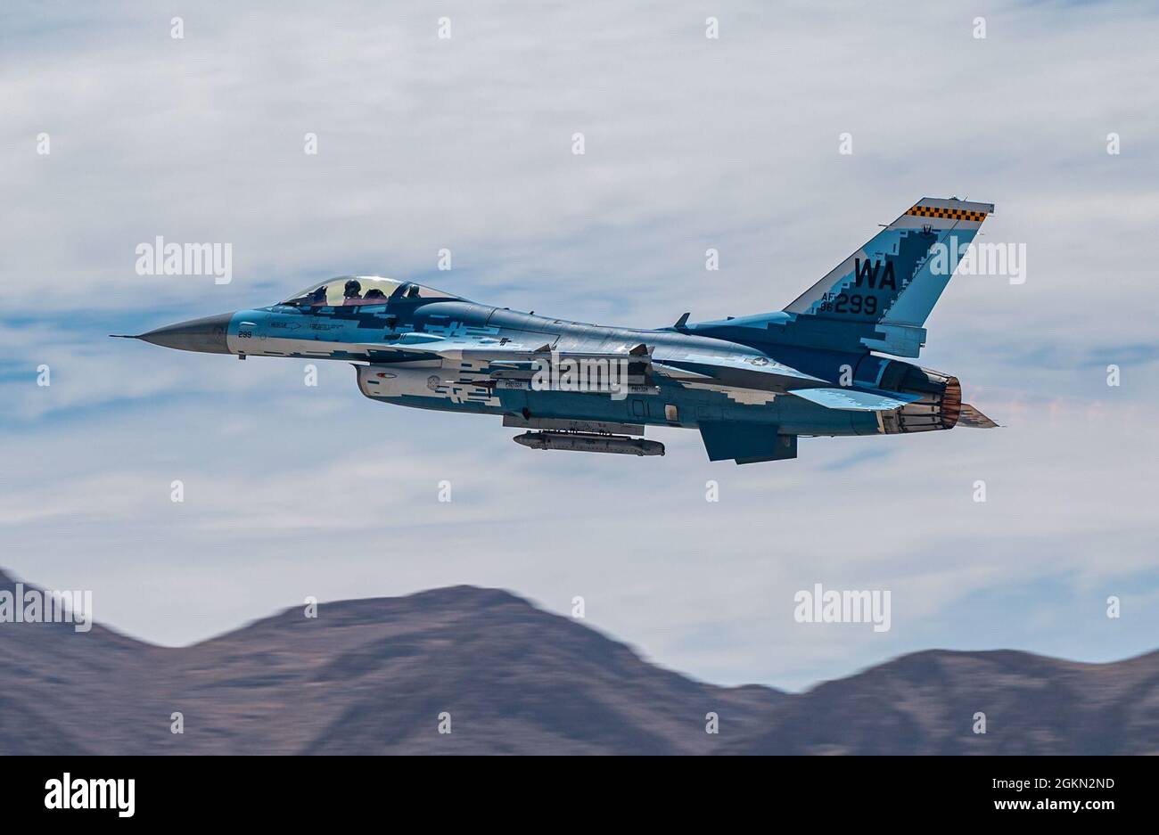 An F-16C Falcon fighter jet assigned to the 64th Aggressor Squadron, takes off  during a U.S. Air Force Weapons School Integration exercise at Nellis AFB, Nevada, June 2, 2021. Aggressor pilots are highly skilled in adversarial tactics and provide realism to U.S. and allied forces during training exercises. Stock Photo