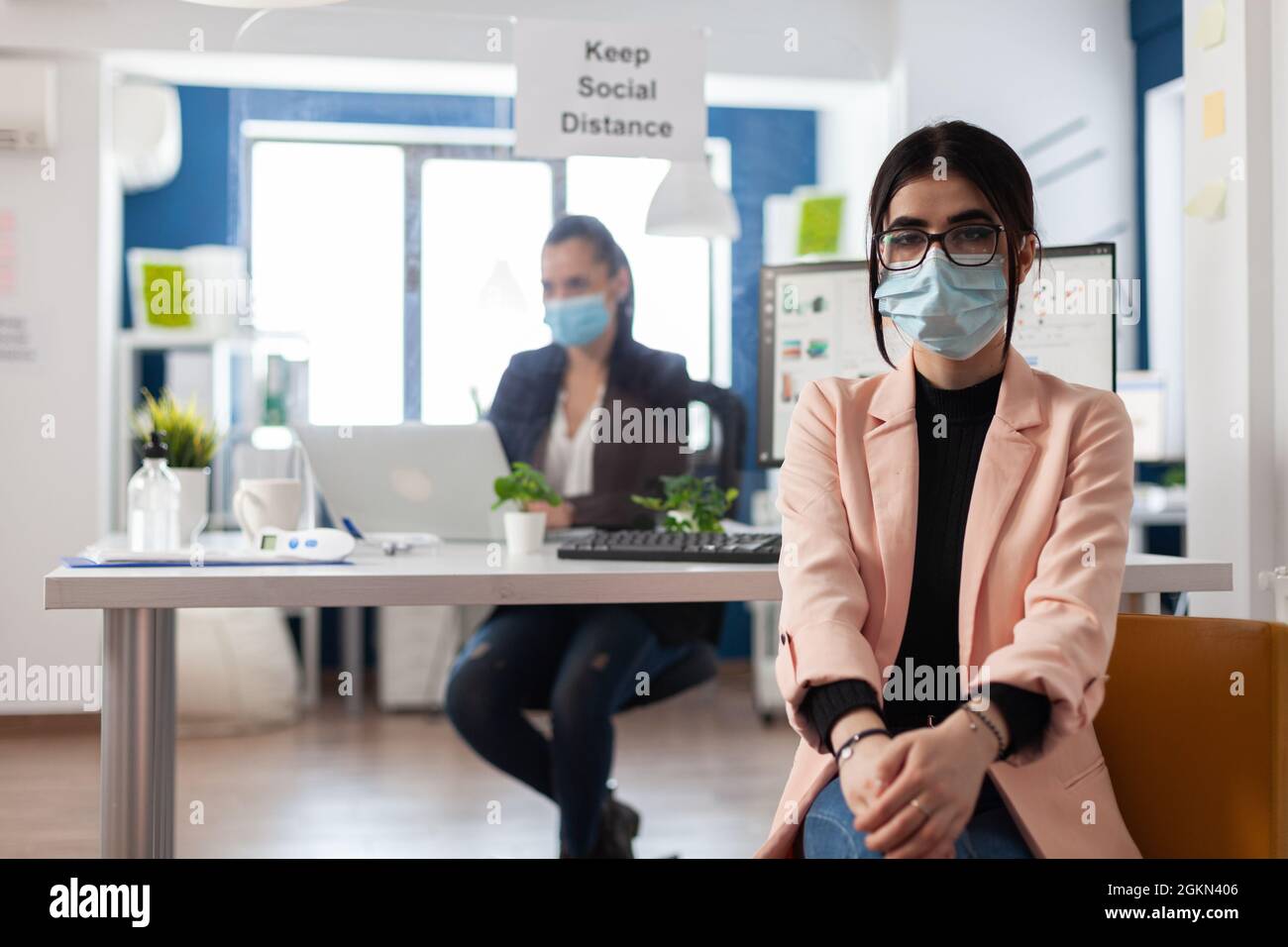 Portrait of executive manager wearing protective medical face mask ...
