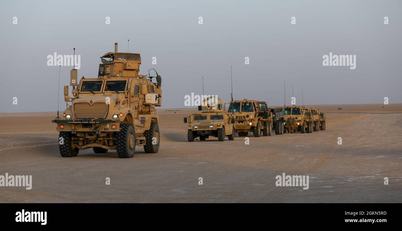 A MaxxPro Mine Resistant Ambush Protected (MRAP) vehicle belonging to Task Force Iron Valor waits in a column to move to a firing position at Udairi Range, Kuwait, June 2, 2021. TF Iron Valor conducted a night exercise to help Soldiers better prepare for live fire missions. Stock Photo
