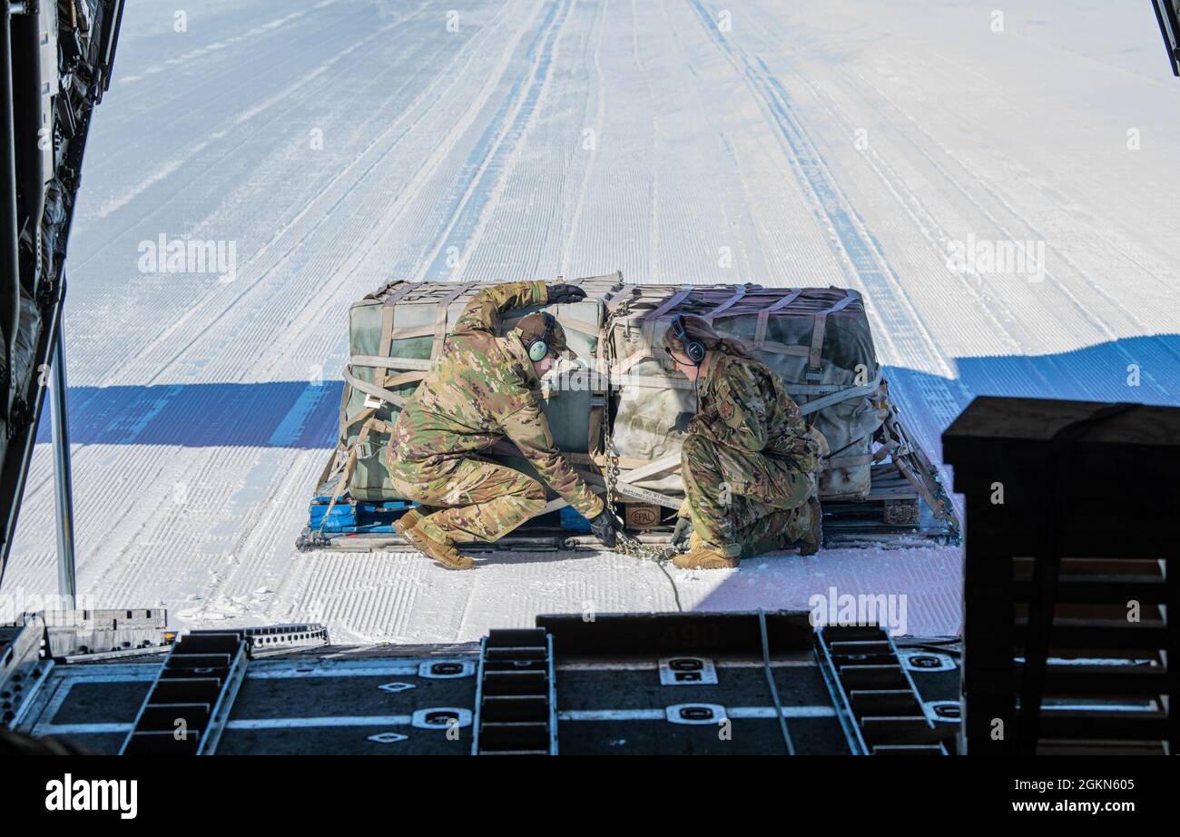 Airmen assigned to the 109th Airlift Wing check a cargo pallet while participating in a training mission at Raven Camp. Raven Camp is used to train members on landing on ice runways, polar airdrops and operating in the snow and ice conditions. The 109th operates in Greenland April-August each year to complete resupply missions for the National Science Foundation and polar operations training. Stock Photo