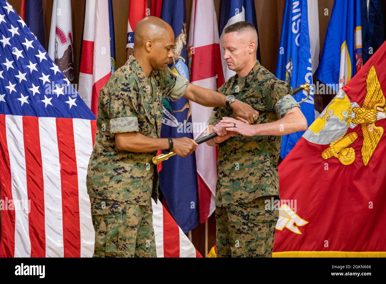 Sgt. Maj. Jason Wolken (right), sergeant major, Force Headquarters Group (FHG), receives a noncommissioned officer's sword from Brig. Gen. Sean Day, commanding general, FHG, during the sergeant major relief and appointment ceremony at Marine Corps Support Facility New Orleans on June 3, 2021. Stock Photo
