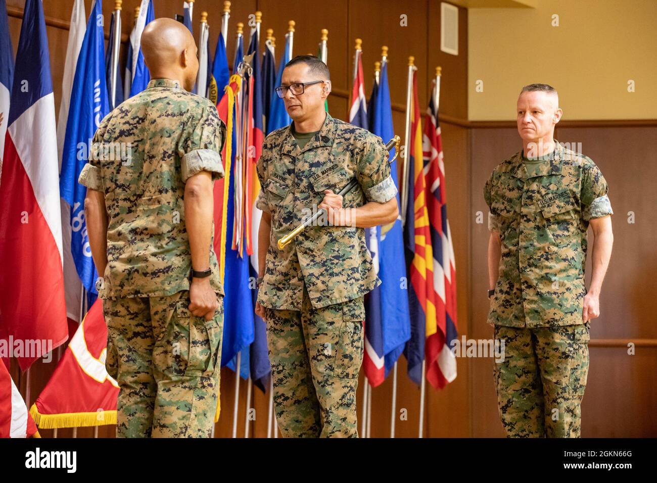 Sgt. Maj. Michael Payne (middle), sergeant major, Force Headquarters Group (FHG), prepares to pass a noncommissioned officer's sword during a relief and appointment ceremony at Marine Corps Support Facility New Orleans on June 3, 2021. Stock Photo